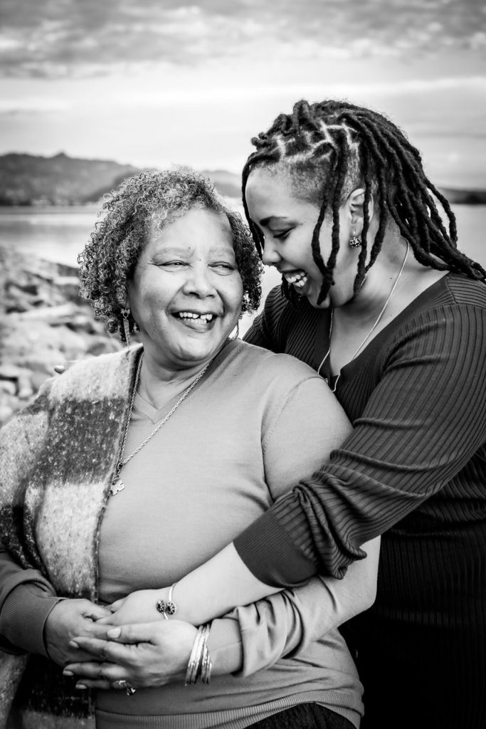 Black and white portrait of mother laughing with daughter beside San Francisco Bay by photographer Shelly Rivoli