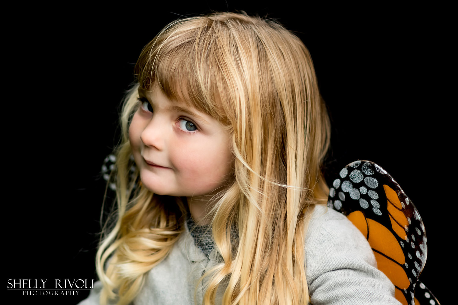 Children's portrait of young girl in butterfly wings by Shelly Rivoli