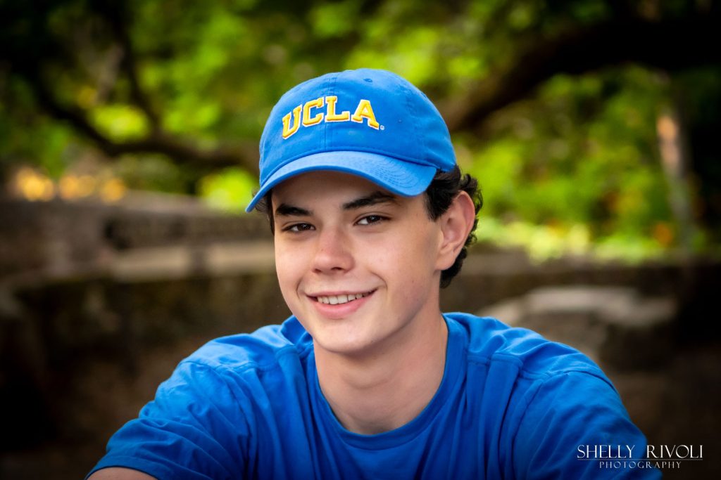 outdoor Bay Area senior portrait of boy in UCLA hat by photographer Shelly Rivoli