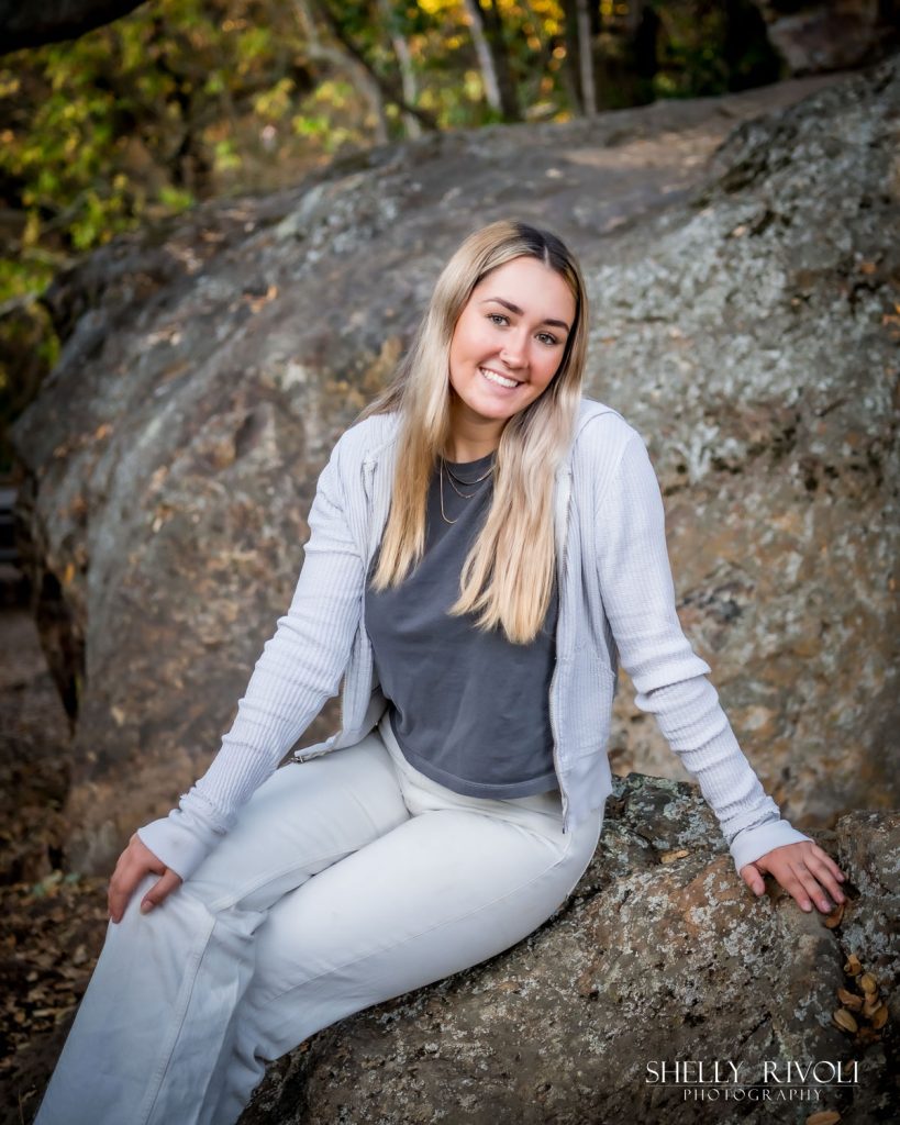 Outdoor Bay Area senior portrait of teen girl on large boulder by photographer Shelly Rivoli