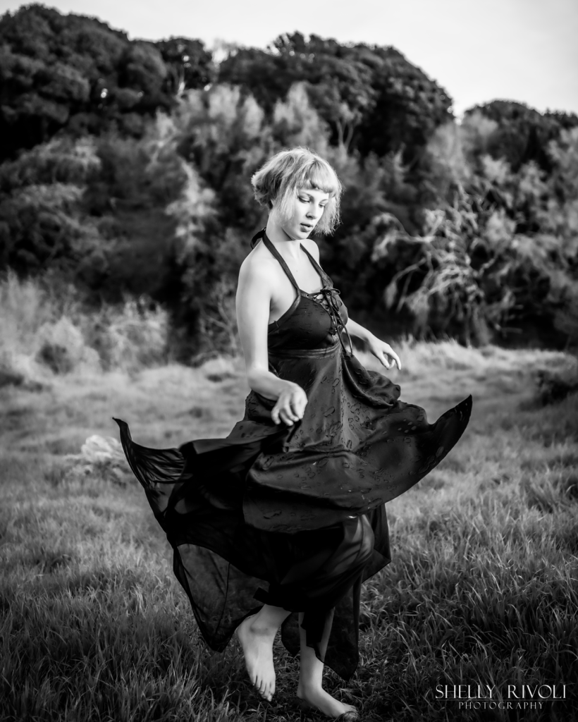 BW Bay Area senior portrait of young woman dancing outdoors in black dress by photographer Shelly Rivoli