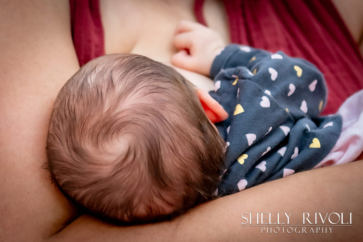 newborn portrait of baby's hair and head while nursing by photographer Shelly Rivoli