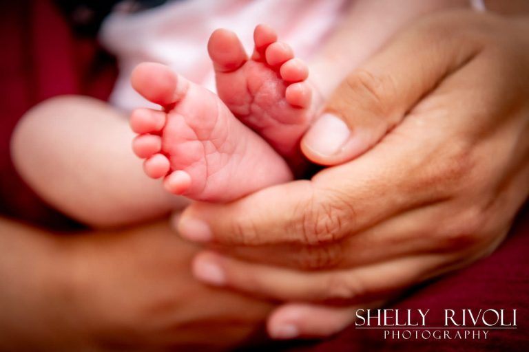 portrait of newborn baby's feet held in mother's hand by photographer Shelly Rivoli