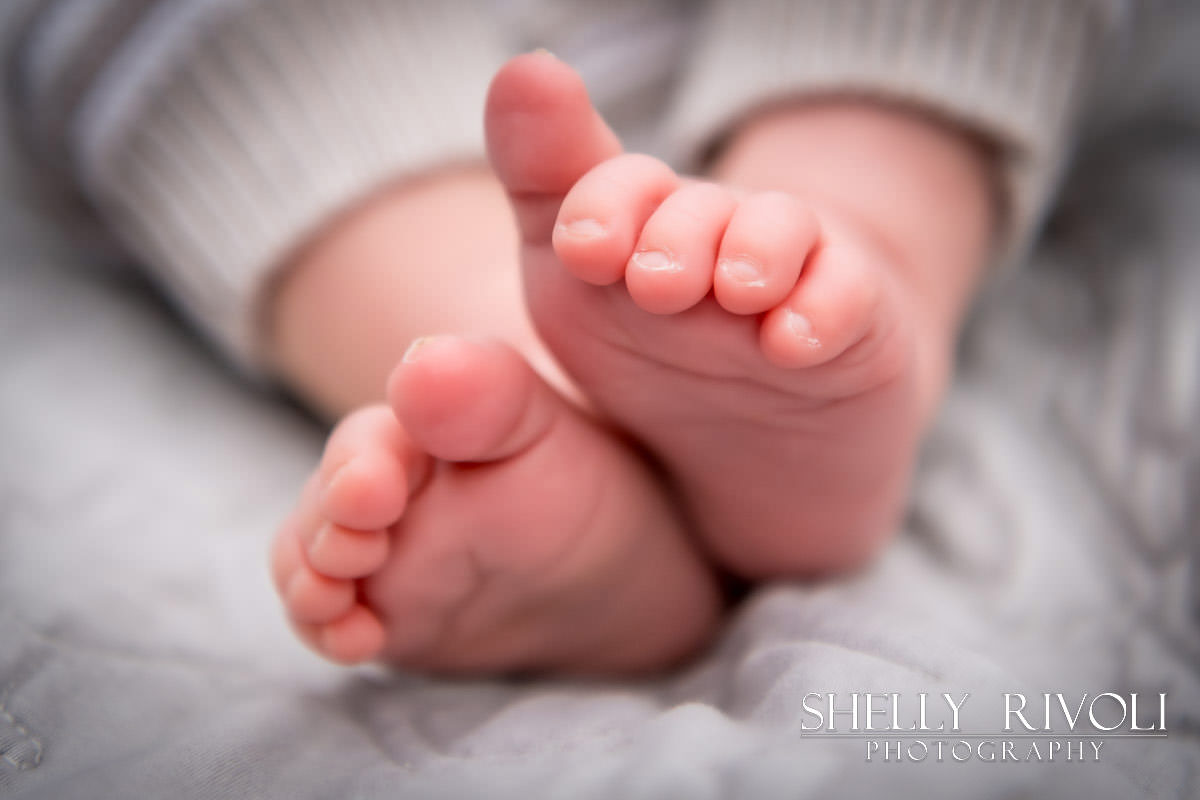 close up of baby feet during lifestyle family newborn photo session by Shelly Rivoli